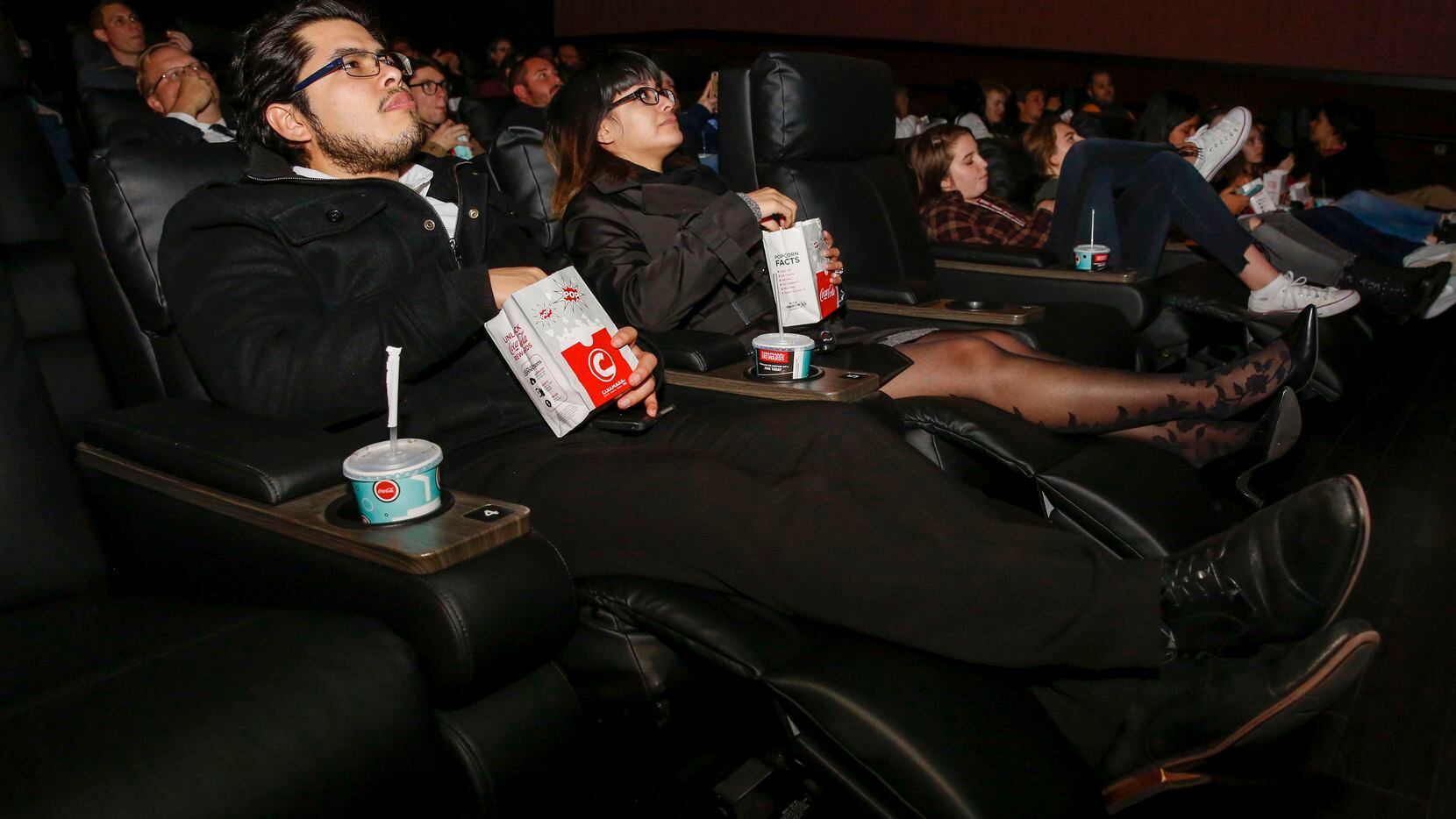 Gustavo Alvarado and Gemma Ortega recline in their seats at a party before the opening of the remodeled Cinemark movie theater in central Plano. For the first time in 25 years, this theater has recliners.