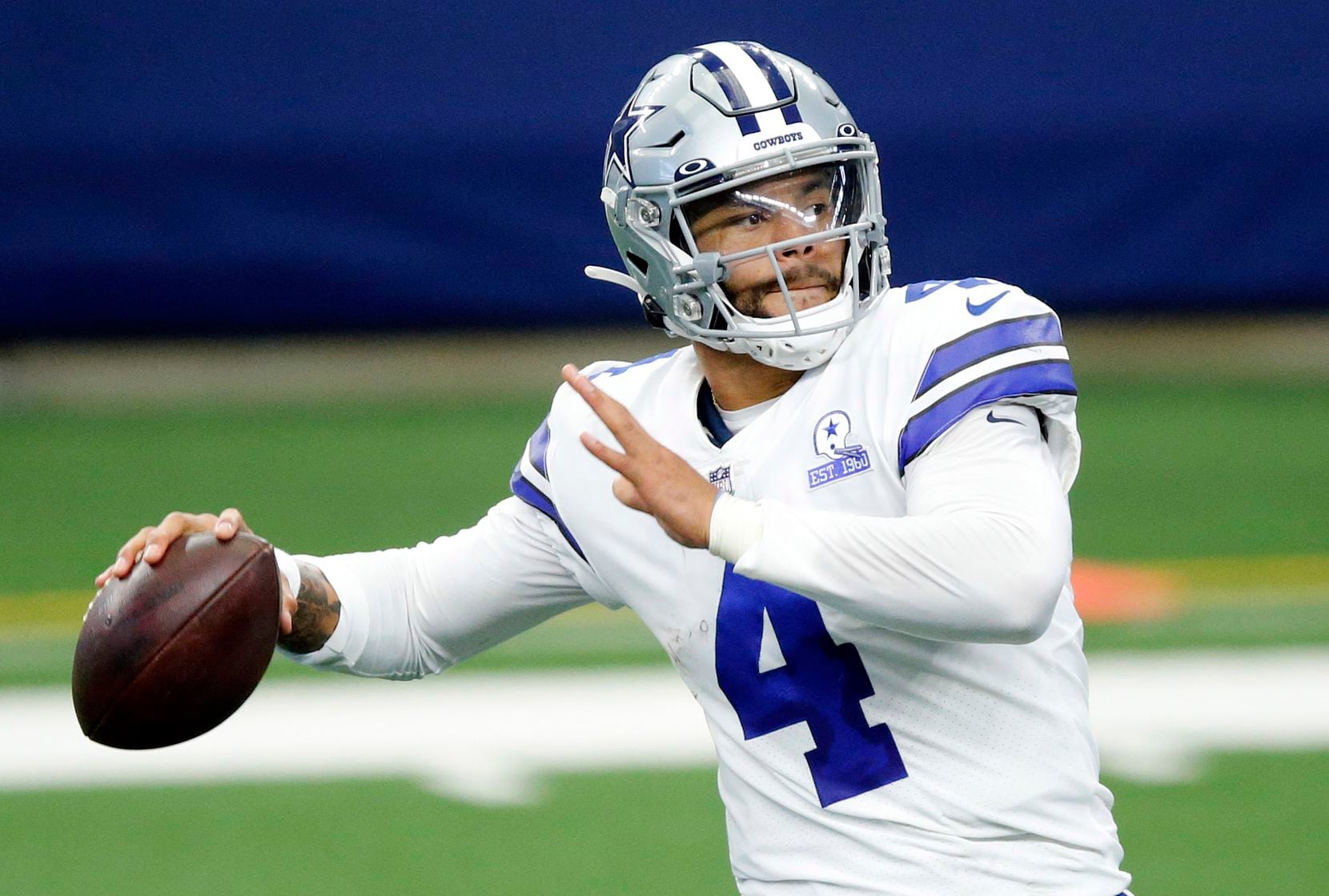FILE - Cowboys quarterback Dak Prescott (4) attempts a pass in the fourth quarter of a game...