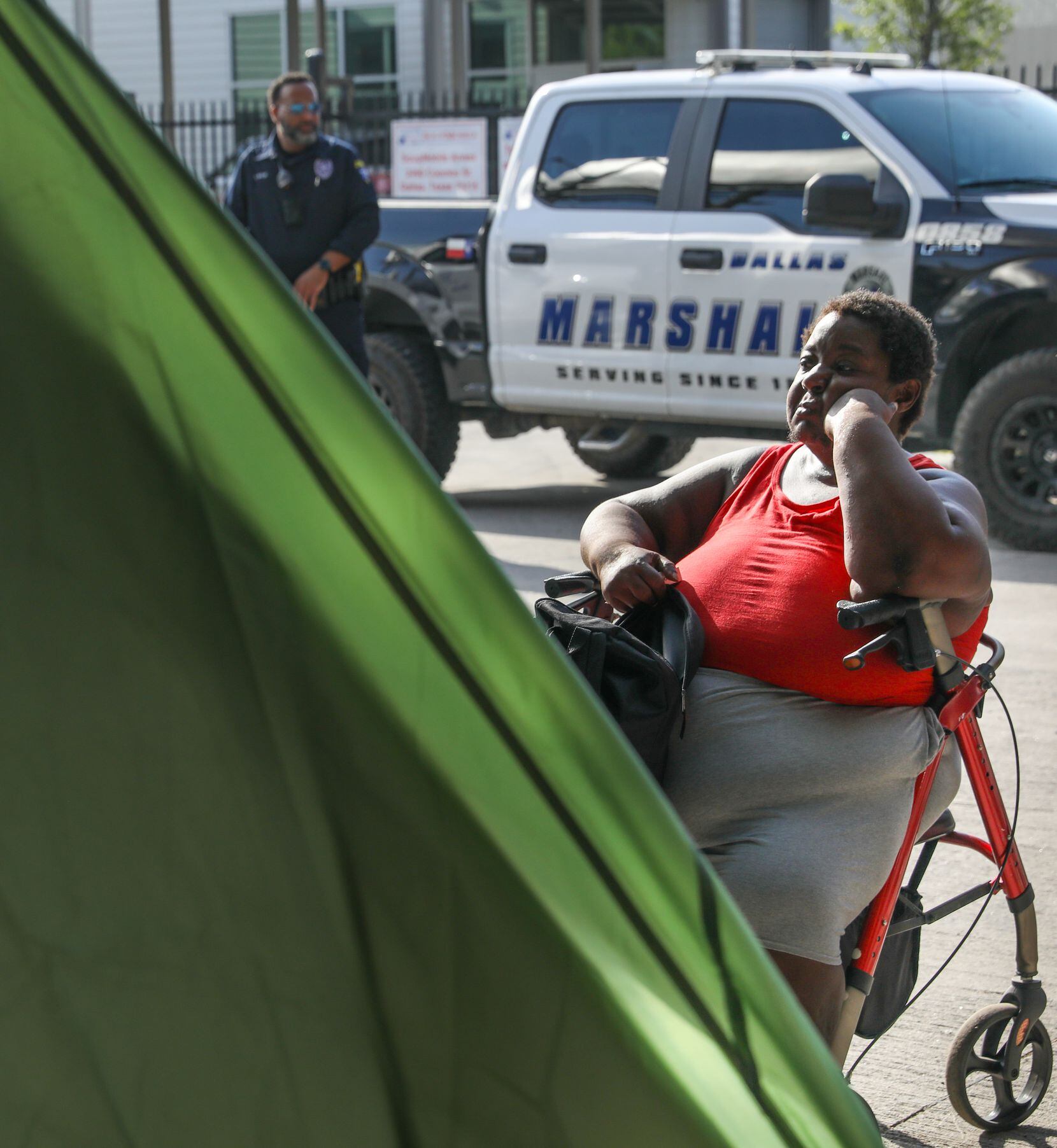 Sonja Jones-Adams looks at her tent at a homeless encampment under a portion of I-45 in...