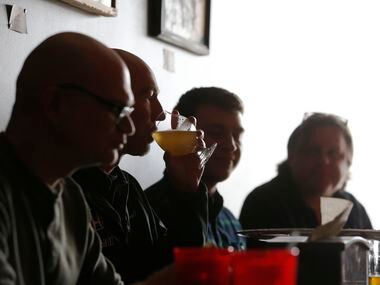 Darrell Caldwell (second from left)  drinks beer and eats with Ernest Adams (left), Jared...