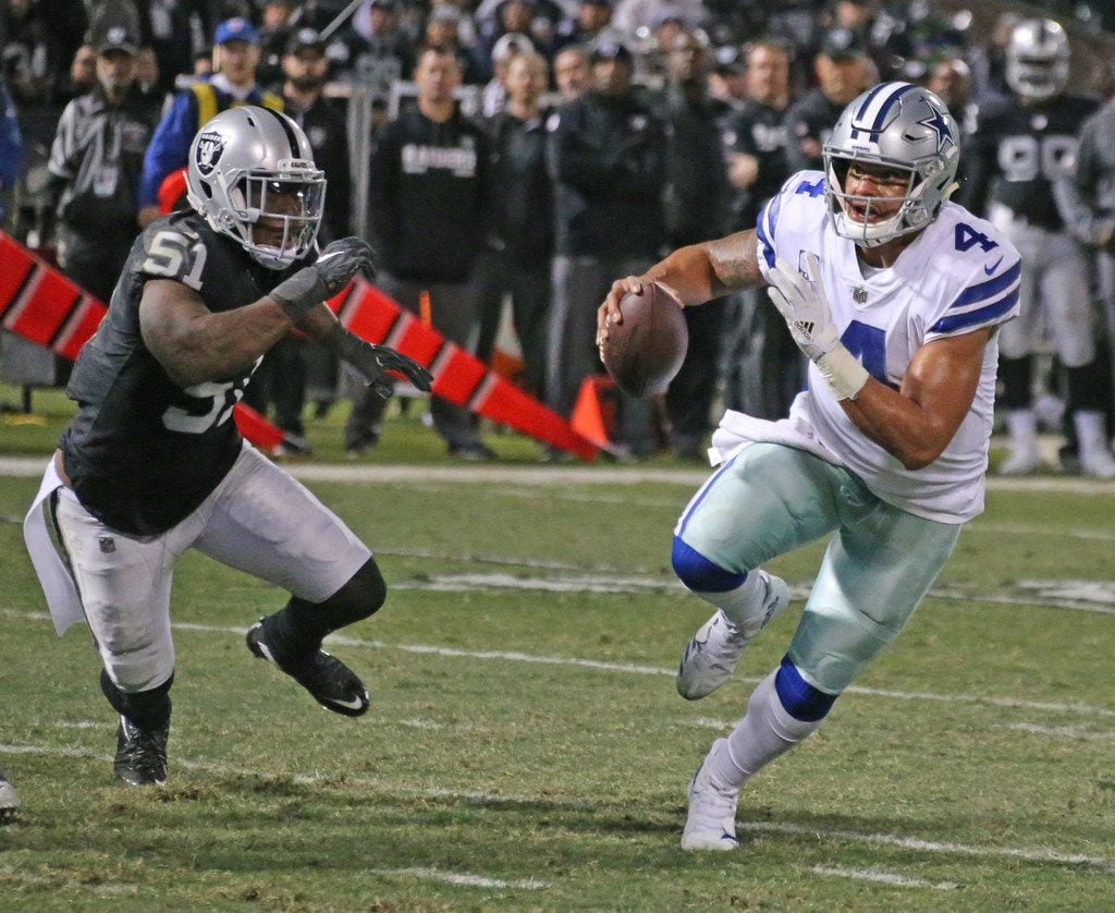 Dallas Cowboys quarterback Dak Prescott (4) scrambles away from Oakland Raiders outside...