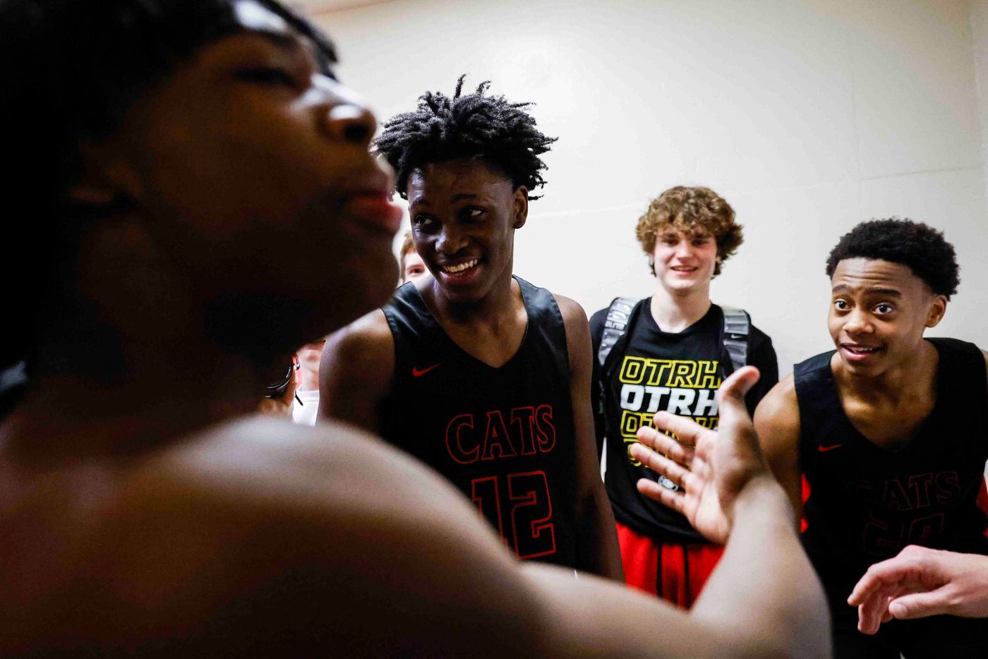 Lake Highlands players including forward Jaire Williams (center) cheer after winning the 6A...