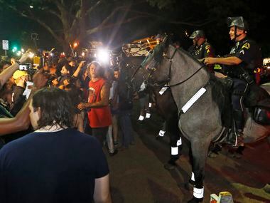 A line of police on horses push protestors back to Young Street after the March Against...