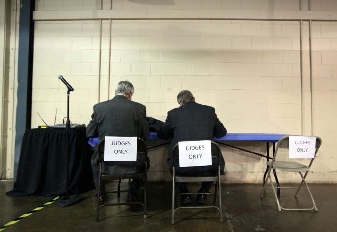 Two judges make their final vote at their own work station during the 2014 Dallas Regional...