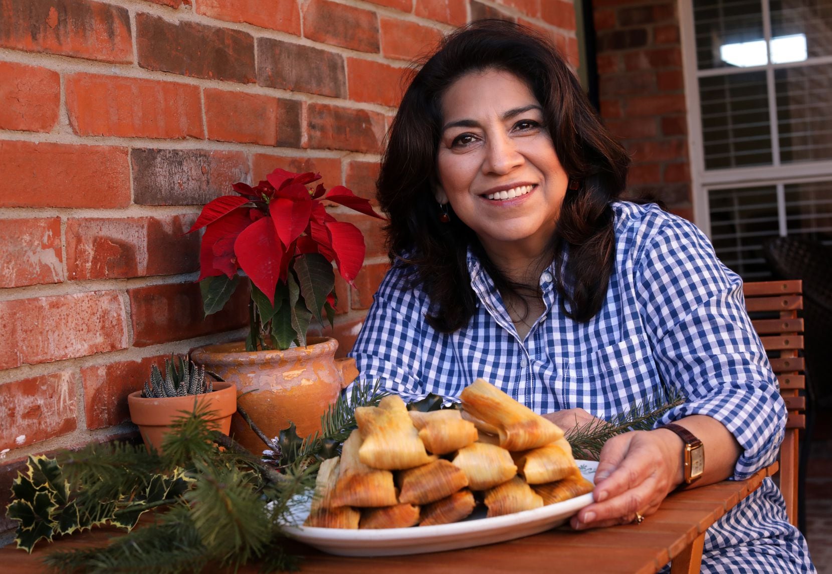 Mely Martinez shows off her homemade tamales at her home in Frisco