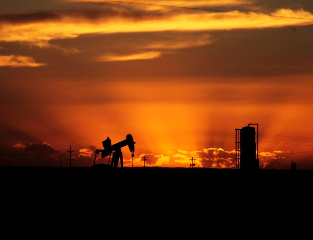 Oil well pumpjacks are scattered about the sparse landscape in Loving County, Texas.  (File...