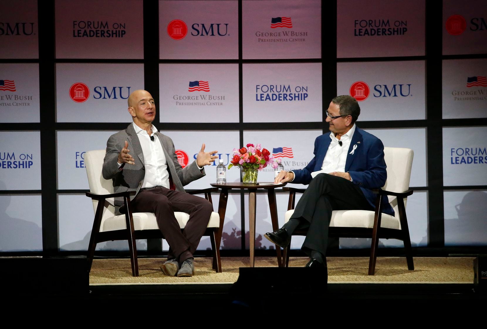 Ken Hersh, president and CEO of the George W. Bush Presidential Center (right), talks with Amazon founder Jeff Bezos at the center's Forum on Leadership in 2018 in Dallas.