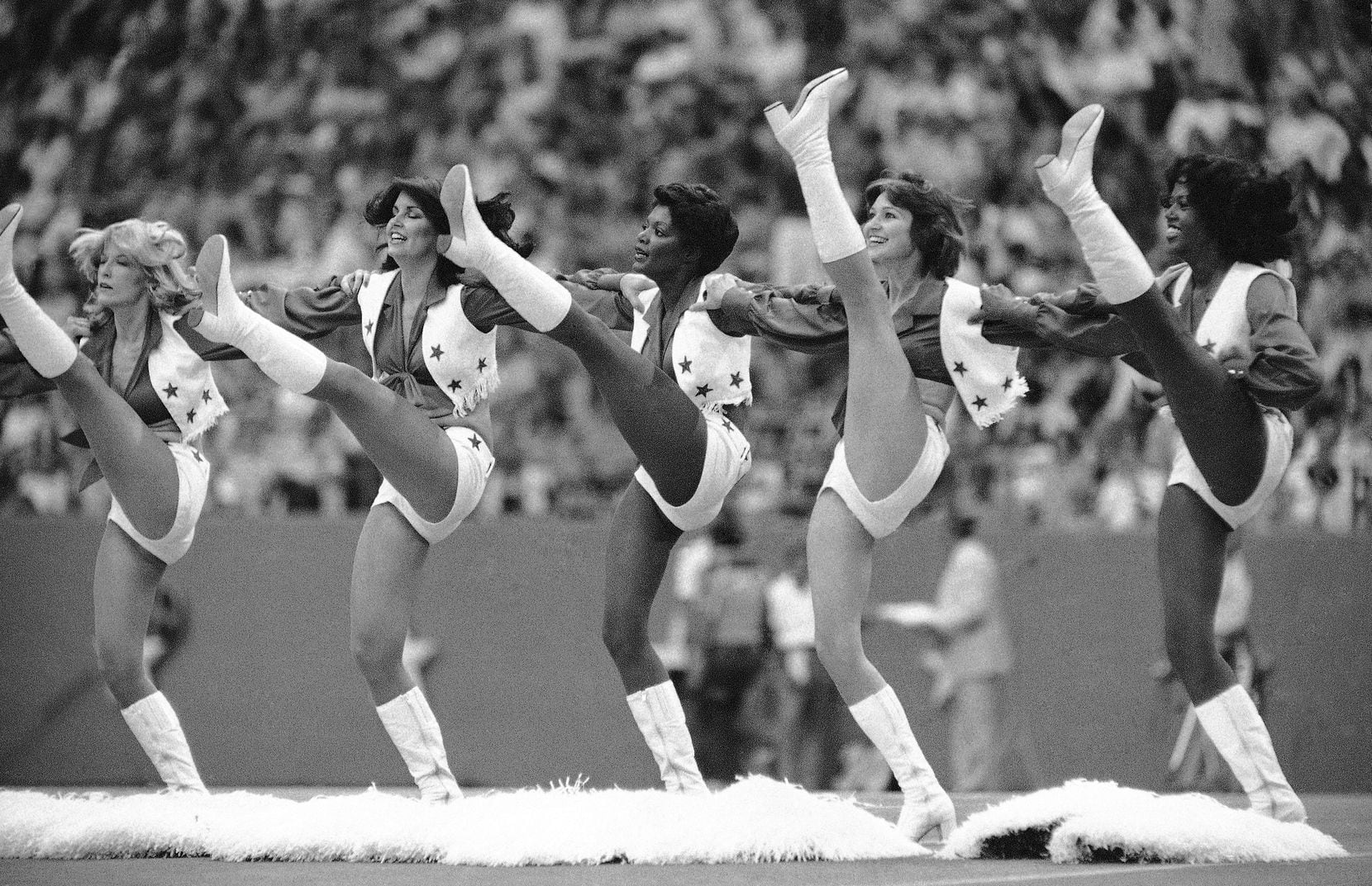 The Dallas Cowboys’ cheerleaders perform high-kicking routine at an NFL game in Miami, Fla., in 1978. 