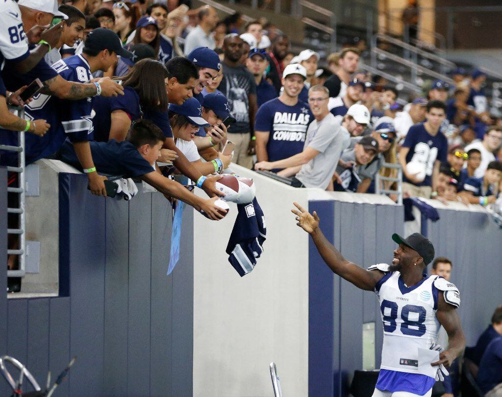 Dallas Cowboys wide receiver Dez Bryant (88) waves at a fan after getting a note from a kid...