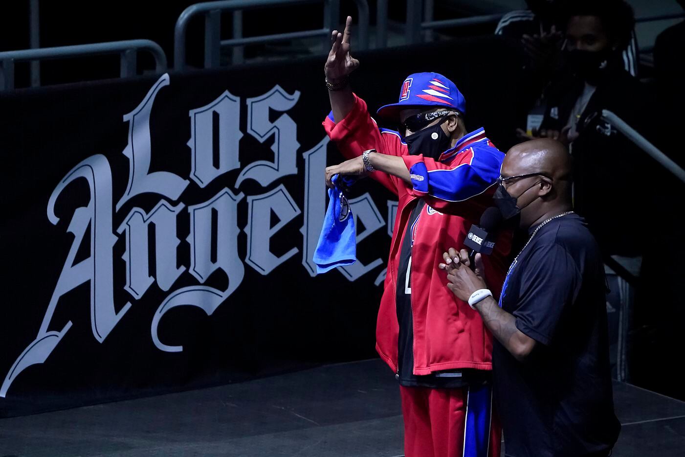 Rapper Tone Loc motions to the crowed during the first half of an NBA playoff basketball game between the Dallas Mavericks and the LA Clippers at Staples Center on Tuesday, May 25, 2021, in Los Angeles.