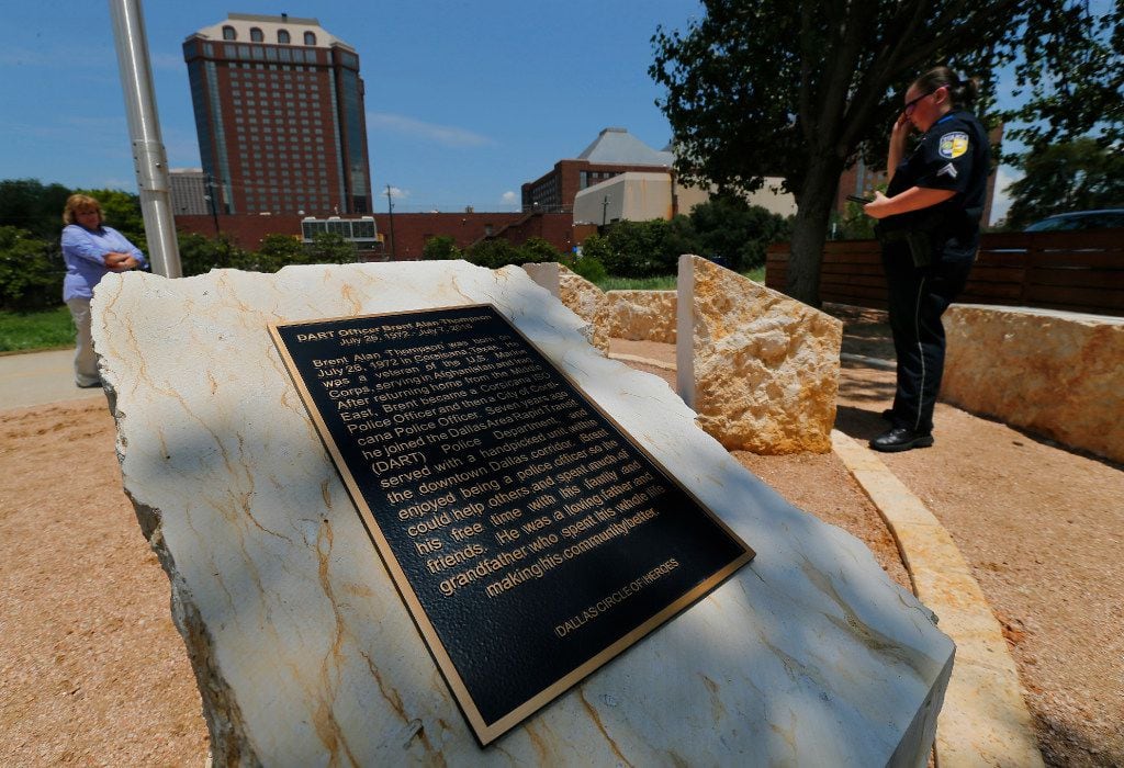 DART Corporal Barbara Underwood (right) reads the plaques for fallen Dallas police officers...