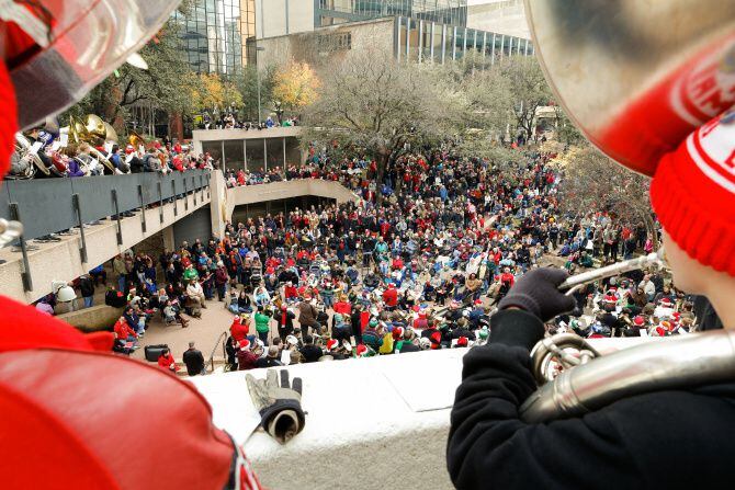 About 250 tuba players and thousands of listeners enjoy Christmas carols during...