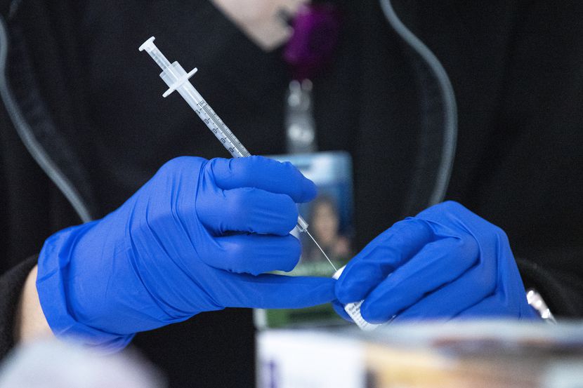 Pharmacist Henna Choi of Parkland Hospital prepares a Pfizer vaccine during a vaccination...