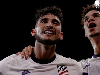 AUSTIN, TEXAS - OCTOBER 07: Ricardo Pepi #16 of the United States celebrates with  Antonee Robinson #5 of the United States after scoring against Jamaica in the second half of a 2022 World Cup Qualifying match at Q2 Stadium on October 07, 2021 in Austin, Texas.