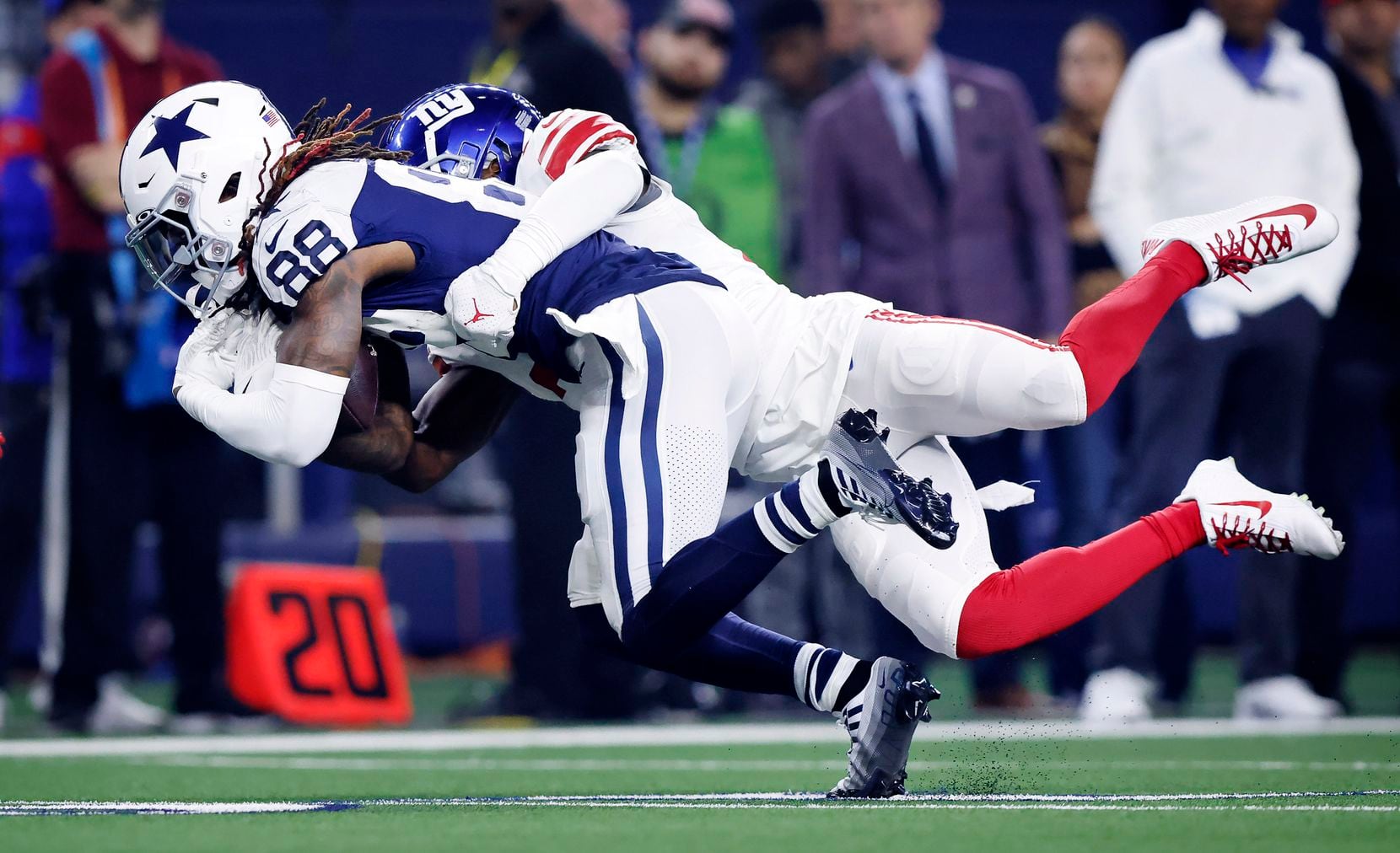 New York Giants cornerback Darnay Holmes (30) tackles Dallas Cowboys wide receiver CeeDee...