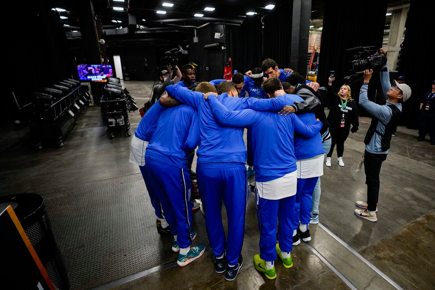 Dallas Mavericks players huddle before heading to the court before Game 7 of an NBA second...