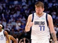 Dallas Mavericks guard Luka Doncic (77) pumps his fist as he comes to the bench after the...