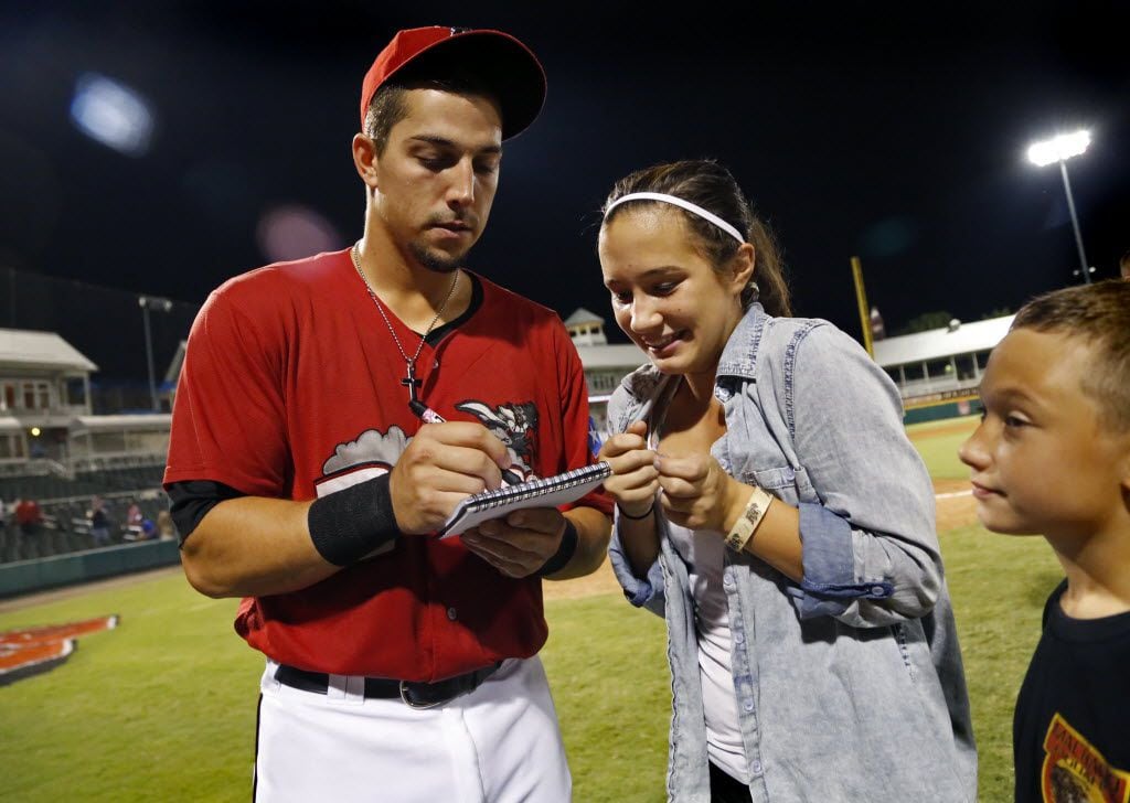 Jake Skole (left) signs an autograph for Angel Brazier, 13, after taking the ALS ice water...