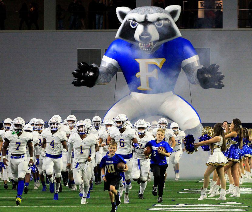 The Frisco team comes onto the field through the team's giant Raccoon blowup tunnel before...