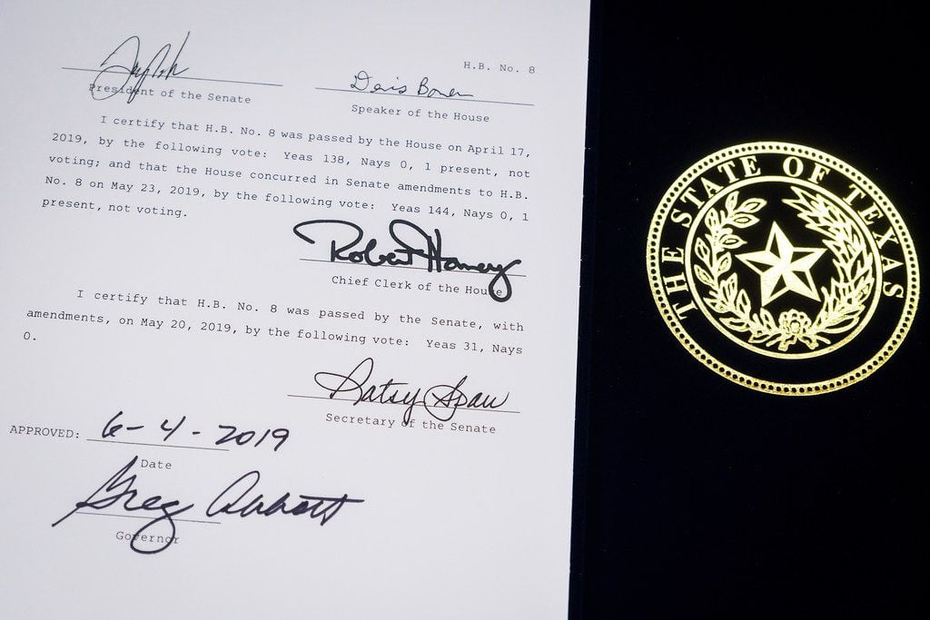 House Bill 8 is displayed with the signature of Governor Greg Abbott following a bill...