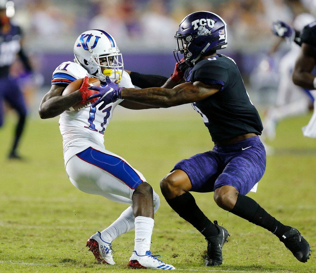 TCU Horned Frogs safety Innis Gaines (6) tries to get a grasp of Kansas Jayhawks wide...