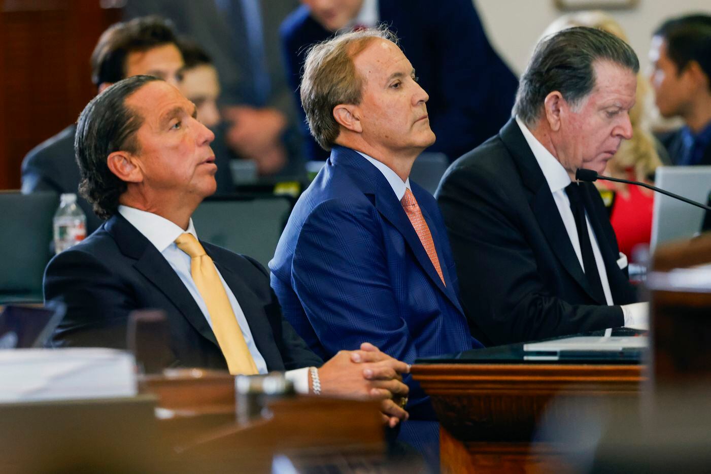 Texas state Attorney General Ken Paxton, center, sits with his attorneys Dan Cogdell, right,...