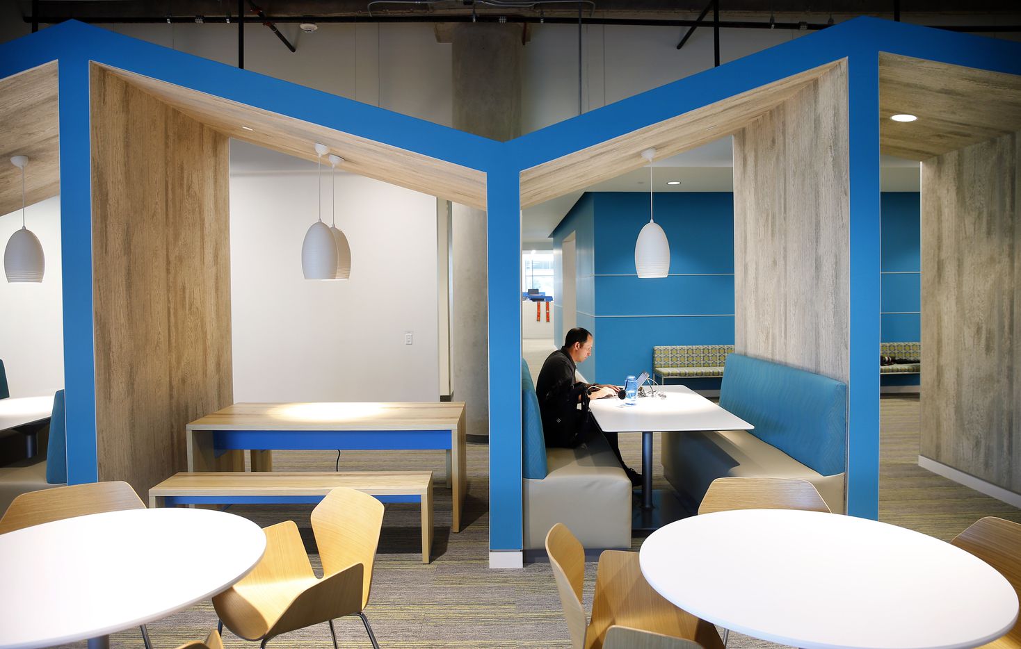 An employee works in Lone Star Commons, a collaborative work space in building E2 of...