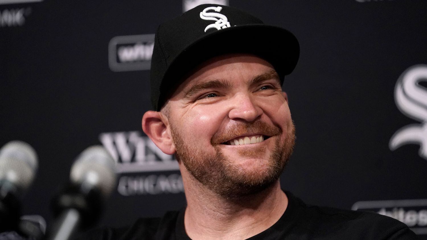 Chicago White Sox's Liam Hendricks smiles as he talks to reporters before a baseball game...
