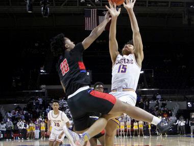 Richardson forward Lorenzo Pearson (15) is fouled by Duncanville guard Rasaun Collier (10)...