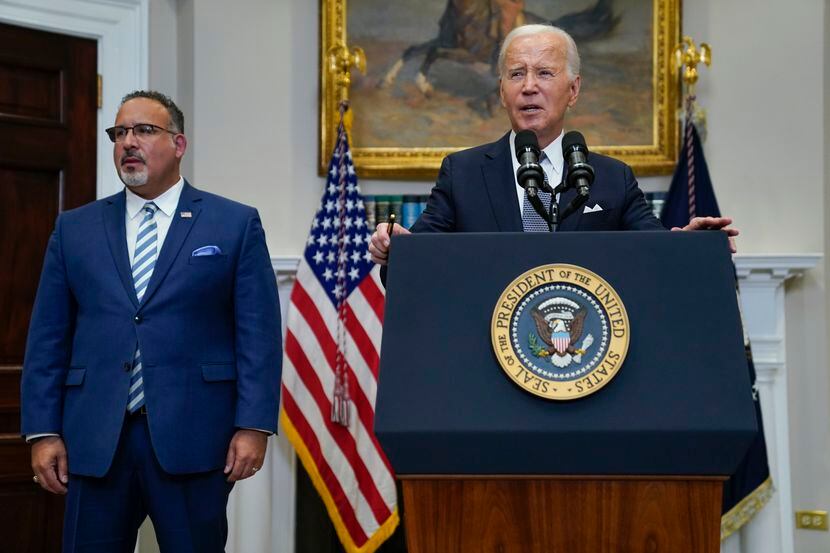 President Joe Biden, with Education Secretary Miguel Cardona, speaks in the Roosevelt Room...