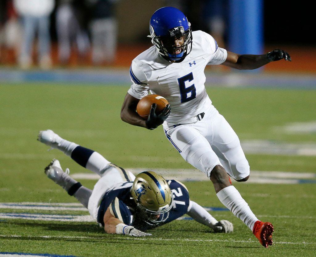 Trinity Christian's Cameron Wilson (6) breaks away from Austin Regents Caleb Rhodes (72) during the first half of play at the TAPPS Division II State Championship game at Waco Midway's Panther Stadium in Hewitt, Texas on Friday, December 6, 2019. (Vernon Bryant/The Dallas Morning News)