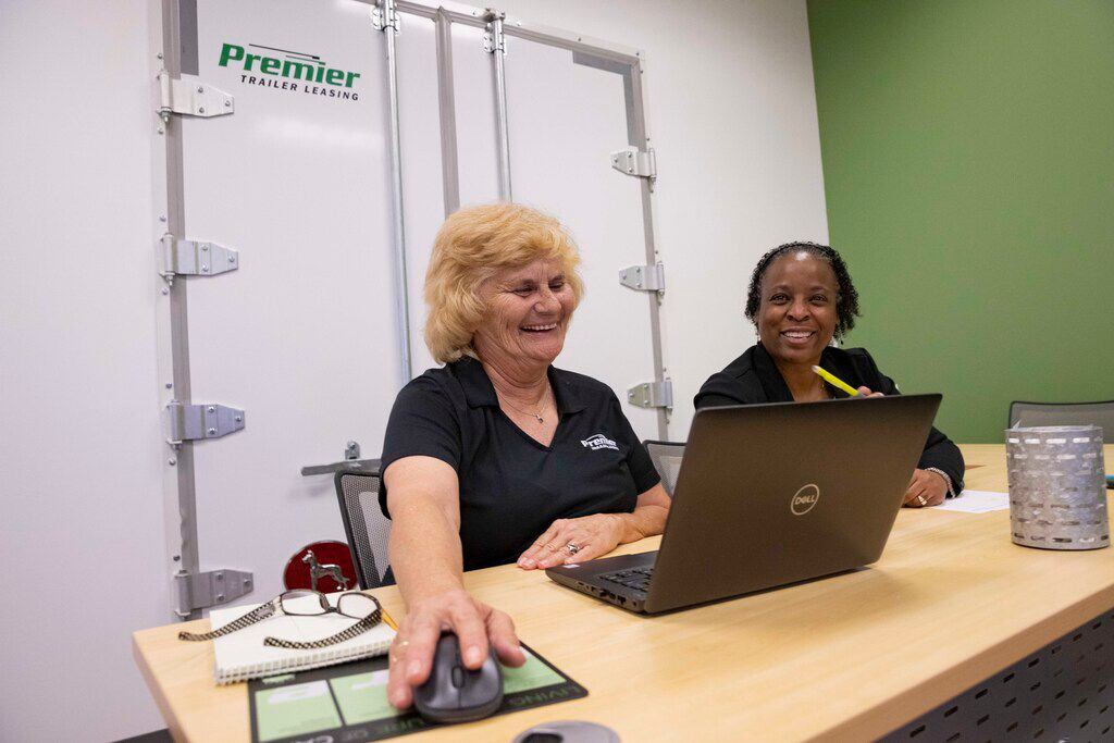Marcia Wickenhauser (left), third party billing specialist, and billing manager Lisa Bell talk through a training session at Premier Trailer Leasing's corporate office in Plano.