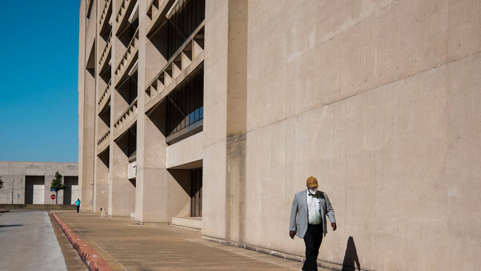 A resident walks outside of Dallas City Hall on Wednesday, September 22, 2021 in Dallas,...
