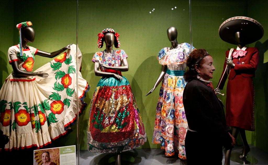 Anita Martinez stands next to her collection traditional ballet folklorico, part of the Eye...