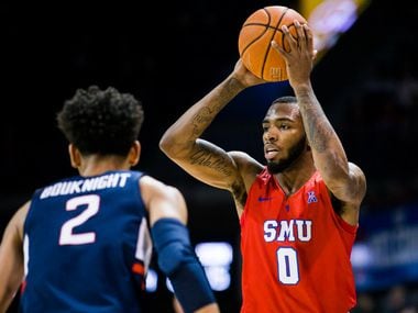 FILE - SMU guard Tyson Jolly (0) looks to pass over UConn guard James Bouknight (2) during the first half of a game on Wednesday, Feb. 12, 2020, at Moody Coliseum on the SMU campus in Dallas.