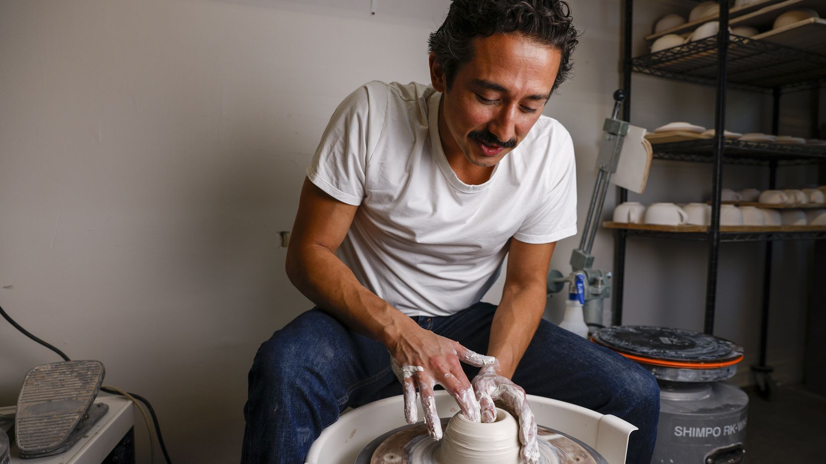 Ceramic artist Marcello Andres works with clay at his studio in Dallas.