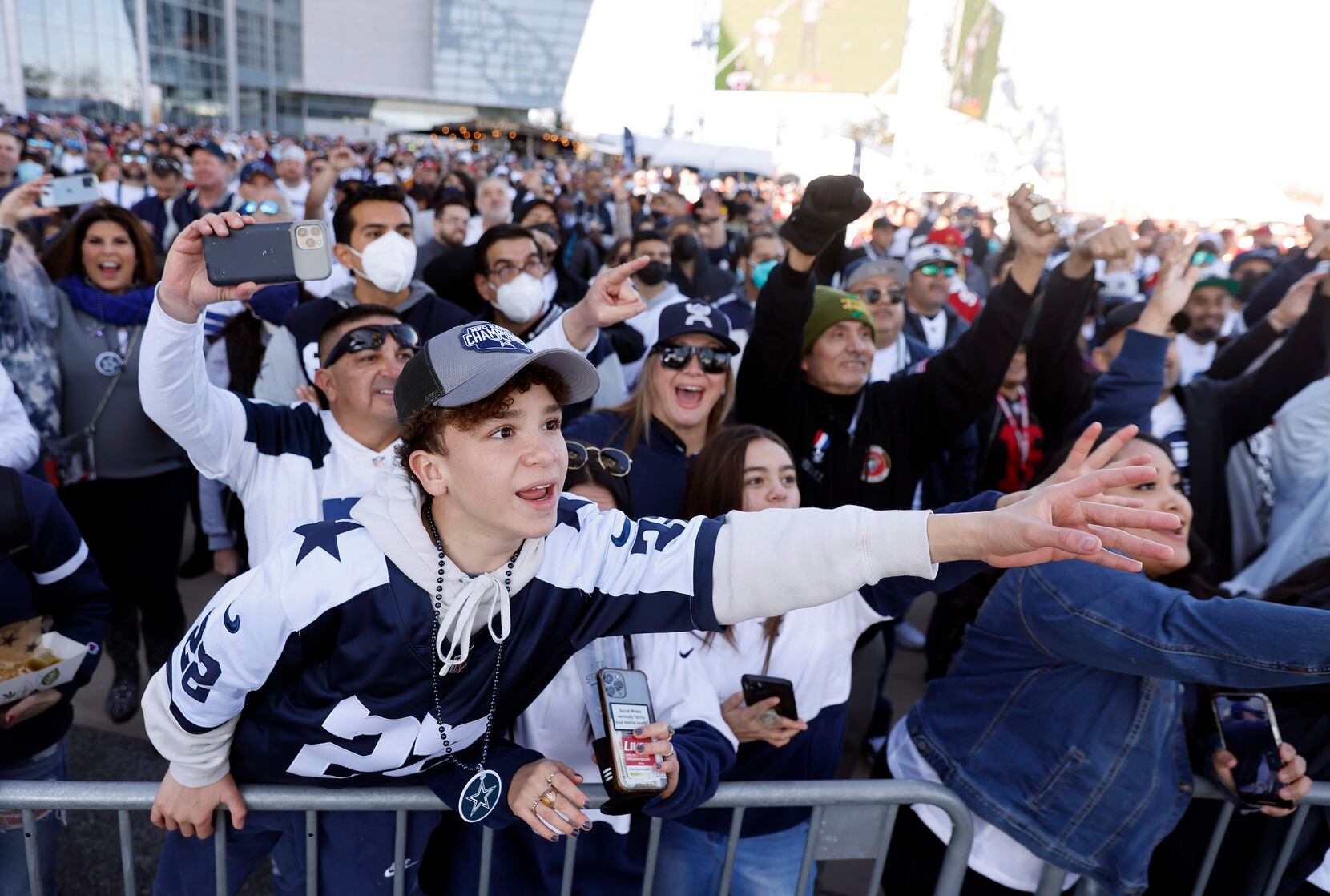 Dallas Cowboys fans cheer former players and cheerleaders who made an appearance on a plaza...