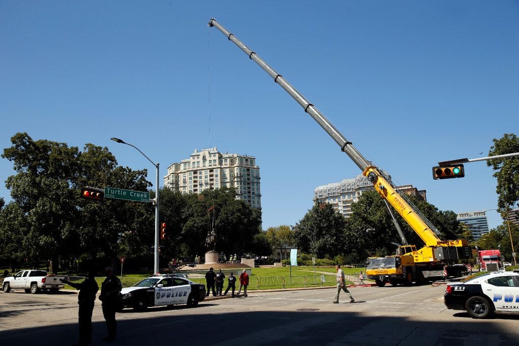 Crewman from Howell Crane and Rigging, Inc attempt to remove the Robert E. Lee statue from...