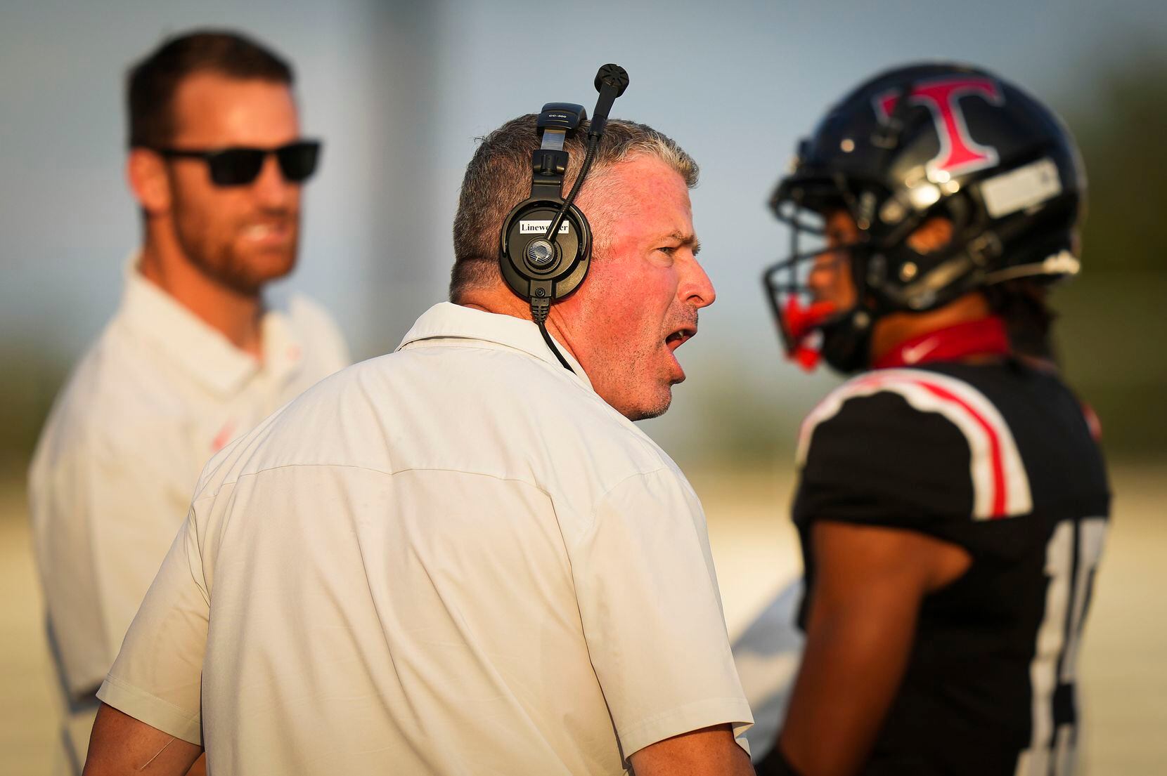 Euless Trinity head coach Aaron Lineweaver works on the sidelines during the first half of a...