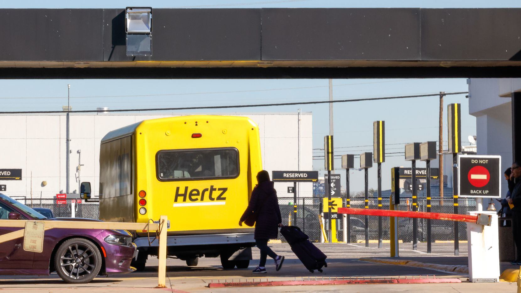 A traveler moved to the car pickup of a Hertz rental car office at Dallas Love Field Airport...