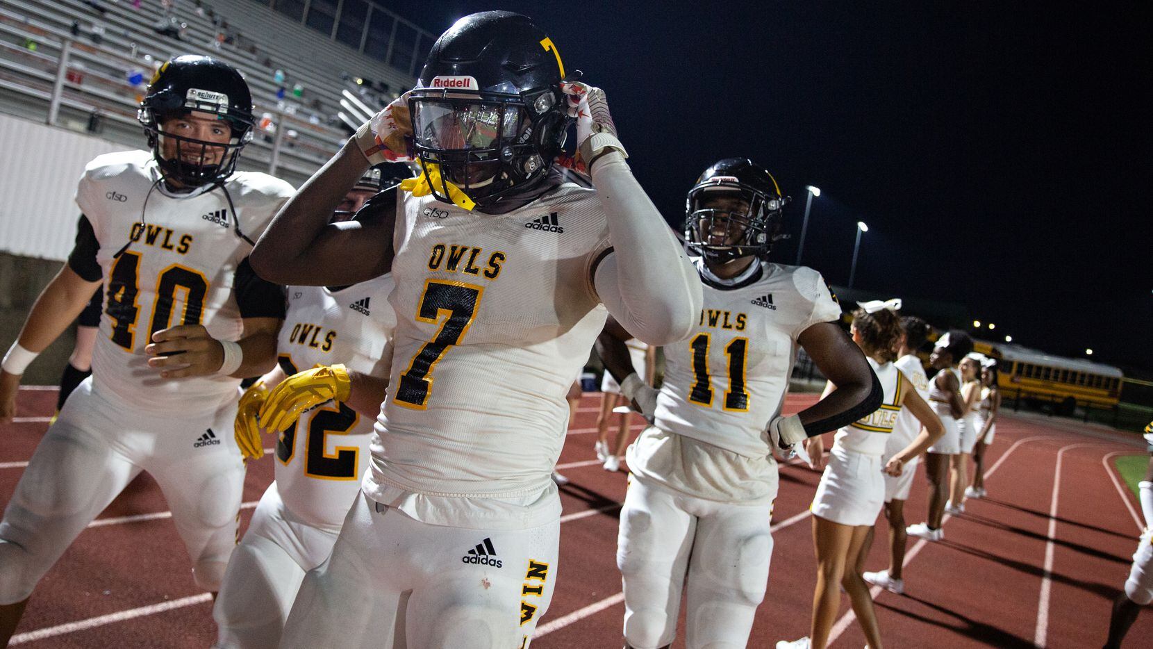 Garland High School defensive back Chace Biddle (7) celebrates after a touchdown with an...