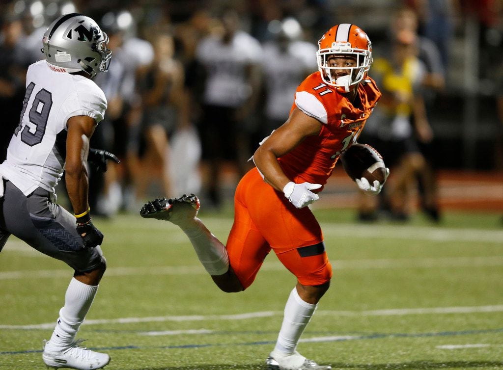 Rockwall's Jaxon Smith-Njigba (11) runs in for a touchdown as he is chased by Arlington...