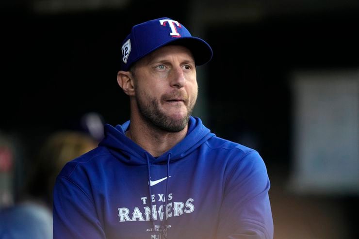 Texas Rangers pitcher Max Scherzer watches from the dugout during the fourth inning of a...