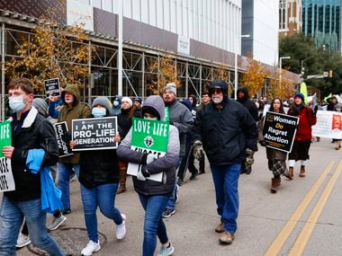 Marchers walk along Ross Ave. during the North Texas March for Life, celebrating the passage and court rulings upholding the Texas Senate Bill 8, on Saturday, Jan. 15, 2022 in Dallas downtown.  
