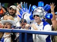 Dallas Cowboys fans, including Gregg Wilson wearing his “Wrecking Ball” helmet, cheer as the teams warm up before an NFL Wild Card playoff football game against the San Francisco 49ers at AT&T Stadium on Sunday, Jan. 16, 2022, in Arlington.