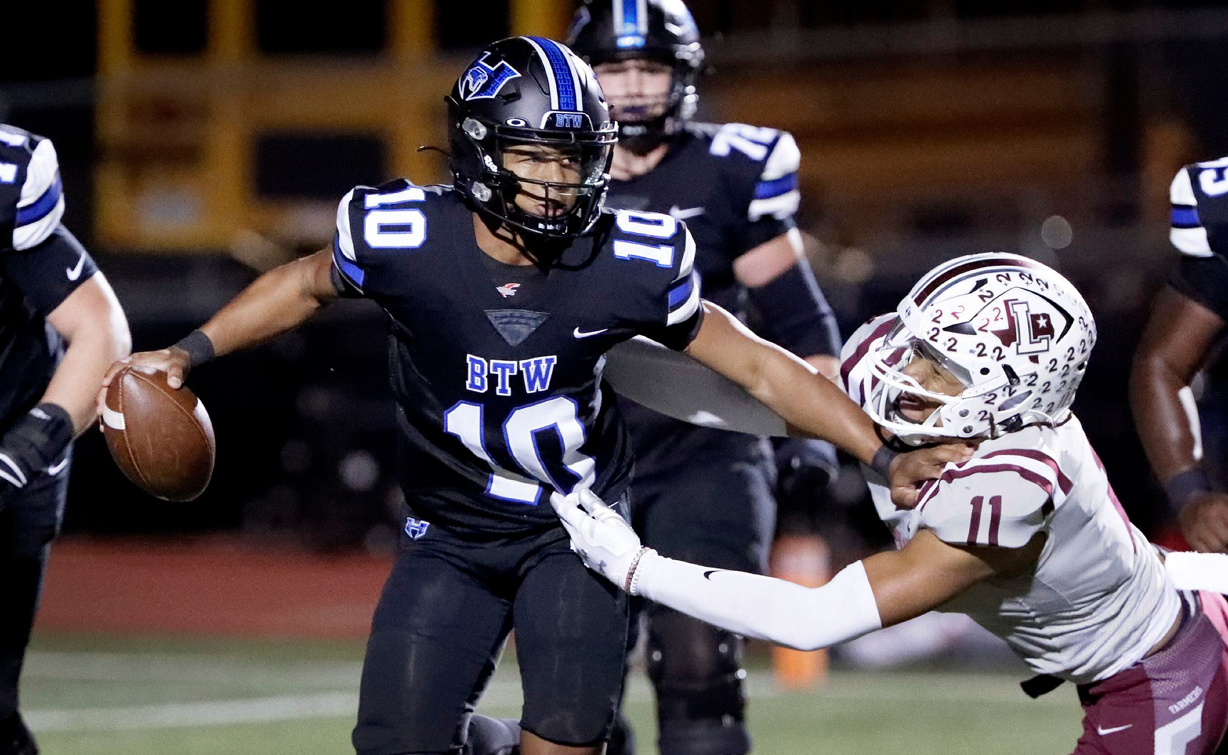 Hebron High School quarterback Patrick Crayton Jr (10) uses a stiff arm to escape Lewisville...