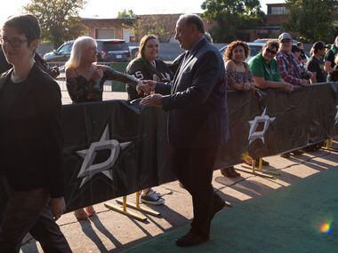 Dallas Stars former general manager Bob Gainey, with Anna Gainey, left, greets fans as he...