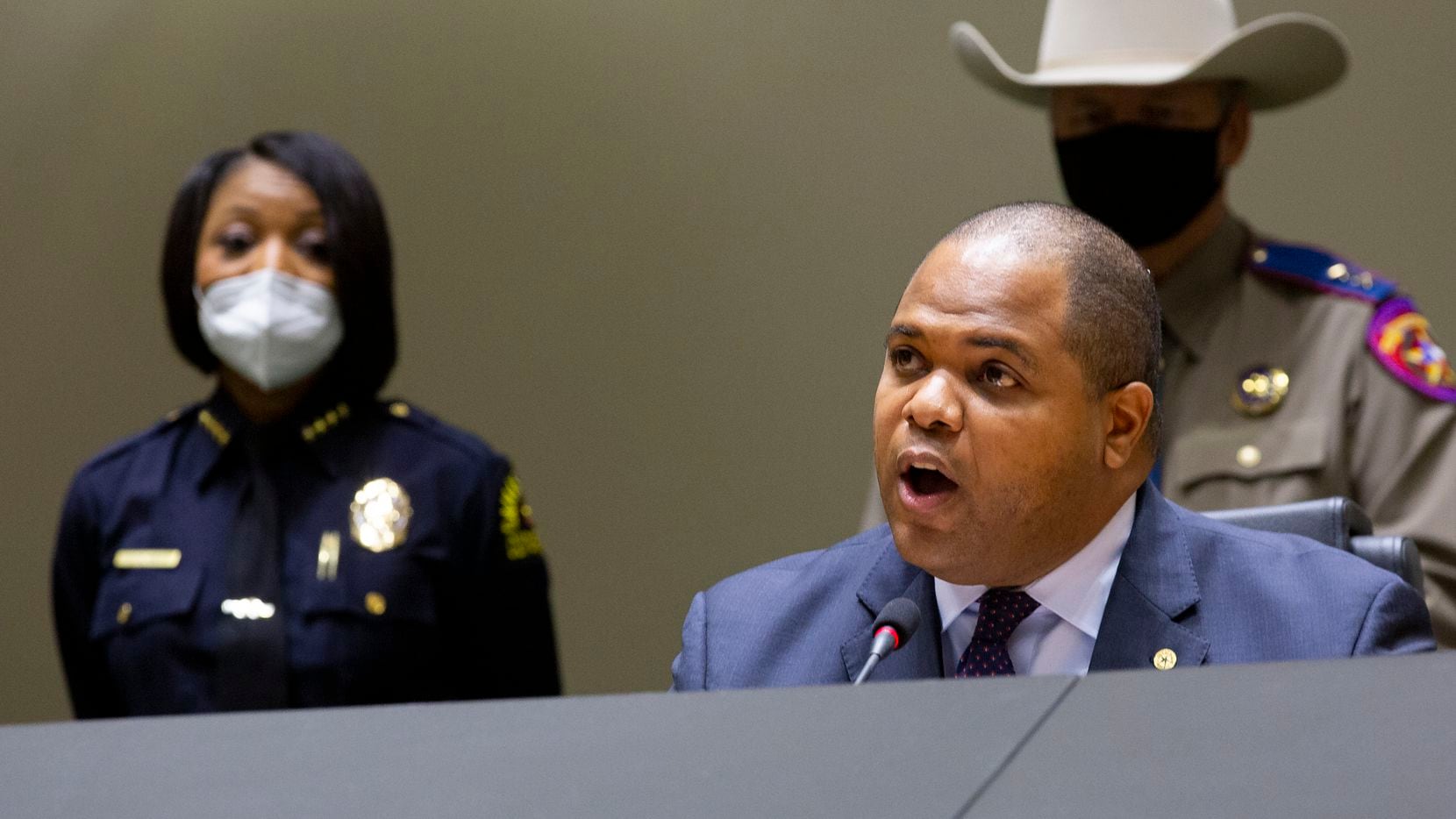 Dallas Police Chief Reneé Hall (left) listens as Dallas Mayor Eric Johnson speaks at a press...