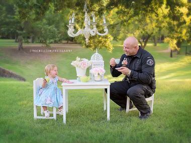 Tarrant County Deputy Constable Mark Diebold shares some tea with Evelyn Hall, whom he...