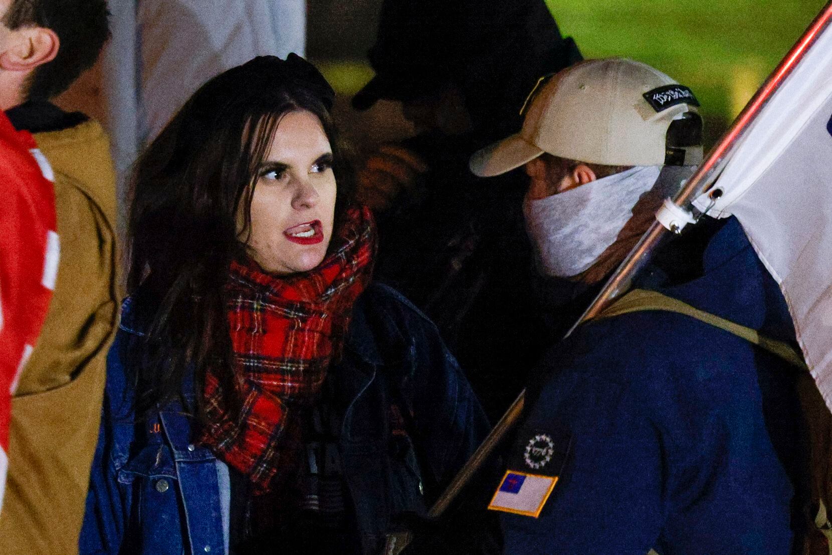 Kelly Neidert of Protect Texas Kids speaks with a right-wing protester during a protest she...